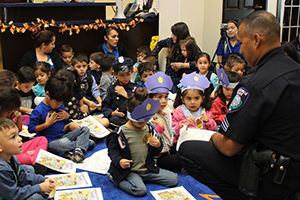 The Brownsville Police Department&acirc;s Sgt. David De Le&Atilde;&sup3;n speaks to children about safety during Community Helper&acirc;s Week at the TSC Early Childhood Center on Oct. 27, 2015