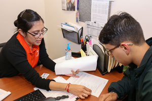 TSC Academic Advisor Alejandra Parra assists a student with course registration at the collegeâ€™s one-stop-shop at the Oliveira Student Services Center.