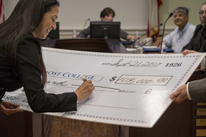 The TSC Foundation, Inc. presented Texas Southmost College a check for $109,000 to be used for scholarships for TSC students. TSC Foundation Chairwoman Tara Rios, D.DS., signs the check during the Sept. 21, 2017 meeting of the TSC Board of Trustees.
