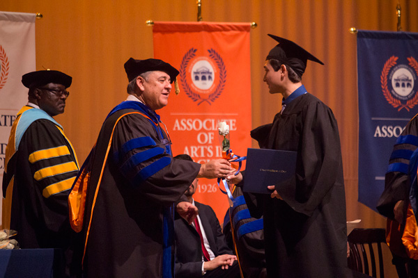 Texas Southmost College Board of Trustees Secretary Ruben Herrera congratulates a graduate during the fall 2016 commencement ceremony on Dec. 17, 2016 at TSCâ€™s Jacob Brown Memorial Auditorium.