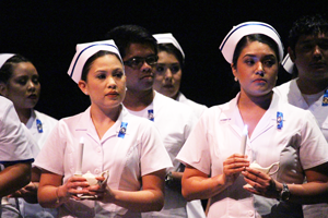 The newly-pinned Texas Southmost College Licensed Vocational Nurse (LVN) graduates hold their candles up as they recite the Vocational Nursing Pledge during the LVN Pinning Ceremony on Aug. 13, 2016 at the TSC Arts Center in Brownsville.