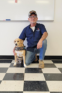 TSC Auto Body intern Carlos Rodriguez and his service dog Ike.