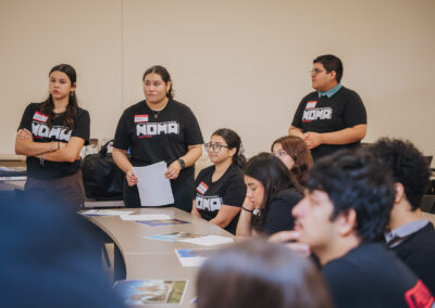 Local high school students listen to a presentation based on the purposes and intricacies of architectural renderings.