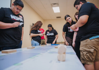 Students discuss strategies for their roles in an interactive board game exercise. The Project Pipeline Architecture Summer Camp featured an array of different activities designed to cultivate the students' interest in the architecture field.