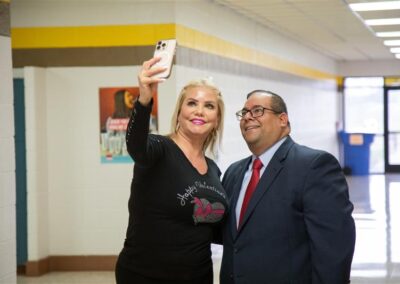 TSC Board Trustee Edward Camarillo, M.P.P.M., stops for a selfie with a Vela Middle School faculty member.