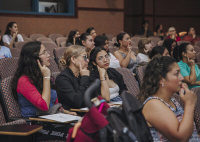 Students in the audience mimic a sign along with their instructor