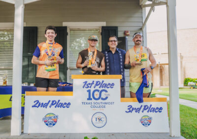 TSC President Dr. Jesus Roberto Rodriguez joins the top three male finishers of the TSC Half Marathon. Ian Andreas (in black shirt) won with a time of 1:30.51.