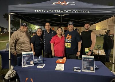 TSC Board Trustee Edward Camarillo and TSC President Dr. Jesus Roberto Rodriguez pose for a picture with spectators and participants at the TSC Historic Run and Half Marathon.
