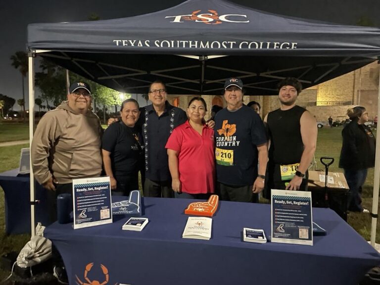 TSC Board Trustee Edward Camarillo and TSC President Dr. Jesus Roberto Rodriguez pose for a picture with spectators and participants at the TSC Historic Run and Half Marathon.