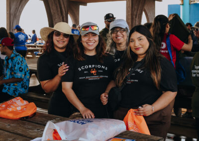 Group photo of Texas Southmost College students participating in a beach cleanup at South Padre Island.