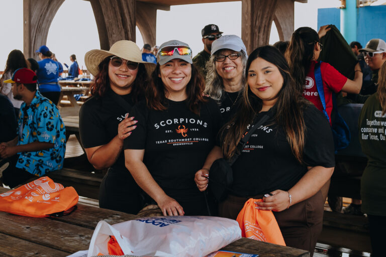Group photo of Texas Southmost College students participating in a beach cleanup at South Padre Island.