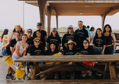 Group photo of Texas Southmost College students participating in a beach cleanup at South Padre Island.