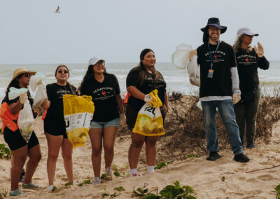 Group photo of Texas Southmost College students participating in a beach cleanup at South Padre Island.
