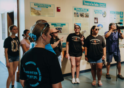 TSC students observe a sea turtle rehabilitation area during a guided tour at Sea Turtle, Inc.