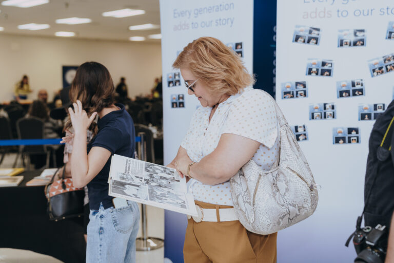A guest looks through a Texas Southmost College yearbook during Generations Day on Sept. 14, 2026, at the Oliveira Student Services Center.