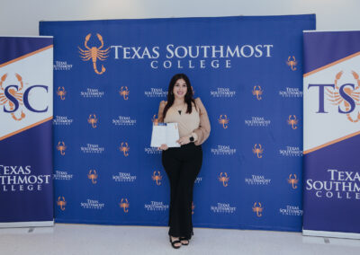 A contributor poses with a copy of Scorpion’s Quill, Issue 2, during a showcase for the literary and arts journal held April 22, 2026, at the Oliveira Student Services Center.