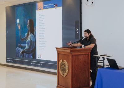 A contributor presents a submission featured in Scorpion’s Quill, Issue 2, during a showcase for the literary and arts journal on April 22, 2026, at the Oliveira Student Services Center.