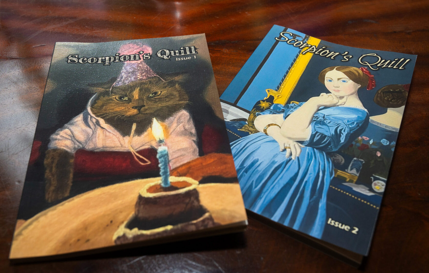 Copies of Scorpion’s Quill, Issues 1 and 2, are displayed on a coffee table during a showcase for the student literary and arts journal.