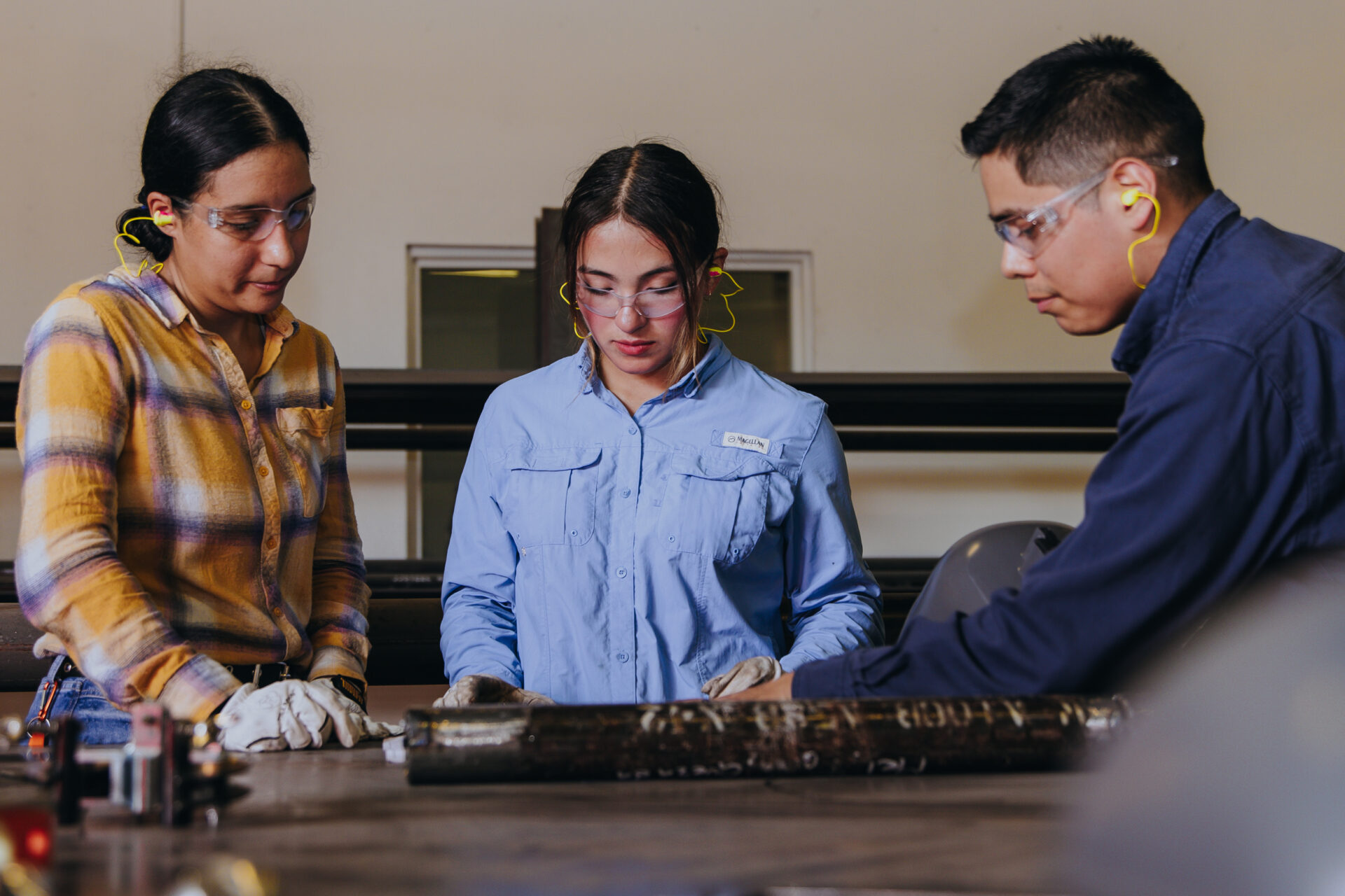 Texas Southmost College students work with an instructor in the school's pipefitting lab.